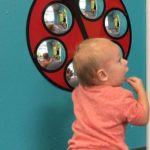 toddler at play center with lady bug